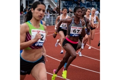 Image Women running hard in a competition on a track.